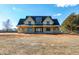 Spacious two-story house with black trim and a metal roof situated on a large lot at 6509 Zebulon Rd, Wake Forest, NC 27587