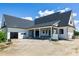 A exterior view revealing a spacious backyard, covered patio, and seamless integration of indoor-outdoor living at 6509 Zebulon Rd, Wake Forest, NC 27587