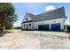 A modern two-car garage with black doors offering plenty of space, complementing the home's architecture at 6509 Zebulon Rd, Wake Forest, NC 27587