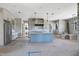 Bright kitchen with a blue island, stainless steel appliances, and pendant lighting at 6509 Zebulon Rd, Wake Forest, NC 27587