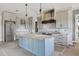 The blue island with stainless refrigerator complements the white cabinets at 6509 Zebulon Rd, Wake Forest, NC 27587