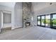 Living room featuring stone fireplace, vaulted ceilings and large glass doors with backyard access at 6509 Zebulon Rd, Wake Forest, NC 27587