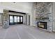Open-concept living room with stone fireplace and wooden beam entryways at 6509 Zebulon Rd, Wake Forest, NC 27587