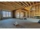 A living room with exposed framing and a fireplace has a construction heater at 6509 Zebulon Rd, Wake Forest, NC 27587