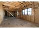 Framed living room with stairs and window ready for your finishing touches at 6509 Zebulon Rd, Wake Forest, NC 27587