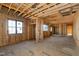 Framed living room with large window and open floor plan ready for finishes at 6509 Zebulon Rd, Wake Forest, NC 27587