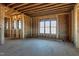 A spacious living room features a large window and exposed framing at 6509 Zebulon Rd, Wake Forest, NC 27587