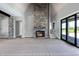 Spacious living room featuring a stone fireplace and sliding glass doors at 6509 Zebulon Rd, Wake Forest, NC 27587