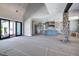 Open-concept living area with kitchen, stone column accents, and sliding glass doors at 6509 Zebulon Rd, Wake Forest, NC 27587