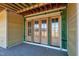 A close up of wood-framed patio doors ready to open to the outside at 6509 Zebulon Rd, Wake Forest, NC 27587