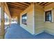 View of the covered patio with a stamped concrete floor and exposed rafters at 6509 Zebulon Rd, Wake Forest, NC 27587