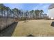 Expansive backyard with established landscaping, and a partial view of a fenced perimeter at 729 Daniel Ridge Rd, Wendell, NC 27591