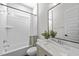 Bright bathroom features a marble countertop, a tiled shower with a curtain, and a modern mirror with stylish decor at 729 Daniel Ridge Rd, Wendell, NC 27591