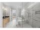An opulent bathroom features floor-to-ceiling marble, a glass shower, and a view of a standalone tub at 729 Daniel Ridge Rd, Wendell, NC 27591
