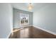 Minimalist bedroom with hardwood floors, large window offering natural light, and calming blue walls create a serene space at 729 Daniel Ridge Rd, Wendell, NC 27591