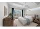Bright bedroom featuring large window, ceiling fan, hardwood floors and a king bed, ideal for relaxing and unwinding at 729 Daniel Ridge Rd, Wendell, NC 27591