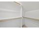 Bright, walk-in closet featuring white walls, carpet and wooden rods for ample storage at 729 Daniel Ridge Rd, Wendell, NC 27591