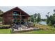 Stunning clubhouse featuring a spacious outdoor patio with dining, lakeside views, and cozy seating arrangements at 729 Daniel Ridge Rd, Wendell, NC 27591