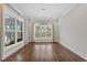 Dining room featuring hardwood floors, a modern chandelier and large windows at 729 Daniel Ridge Rd, Wendell, NC 27591