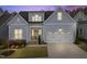 Charming home showcasing light blue siding, a two-car garage, and a well-manicured lawn at 729 Daniel Ridge Rd, Wendell, NC 27591