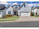 Charming home showcasing light blue siding, a two-car garage, and a well-manicured lawn at 729 Daniel Ridge Rd, Wendell, NC 27591