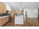 Bright kitchen with white counters, wood cabinets, a black backsplash, and stainless steel appliances at 729 Daniel Ridge Rd, Wendell, NC 27591