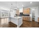 Bright kitchen with white counters, wood cabinets, a black backsplash, and stainless steel appliances at 729 Daniel Ridge Rd, Wendell, NC 27591