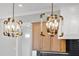 Close-up of modern light fixtures with brass accents and glass panels, adding a touch of elegance to the kitchen at 729 Daniel Ridge Rd, Wendell, NC 27591