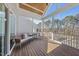 Comfortable screened-in porch with wood floors, inviting furniture, and a peaceful wooded backdrop at 729 Daniel Ridge Rd, Wendell, NC 27591