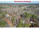 Aerial view of a wooded landscape with a property marked, offering a glimpse of its location near downtown Raleigh at 733 Shadywood Ln, Raleigh, NC 27603