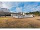 Backyard featuring a white wooden fence enclosing an outdoor space on a sunny day at 7409 Blalock Rd, Bahama, NC 27503