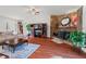 Spacious living room featuring a beautiful stone fireplace and hardwood flooring at 7409 Blalock Rd, Bahama, NC 27503