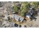 Aerial view of community parking with multiple townhomes surrounded by mature trees at 7712 Falcon Rest Cir, Raleigh, NC 27615