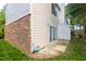 Backyard with siding and brick exterior, sliding glass door, and a patch of grass at 7712 Falcon Rest Cir, Raleigh, NC 27615
