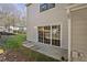 Backyard with retaining wall and sliding glass door entrance at 7712 Falcon Rest Cir, Raleigh, NC 27615