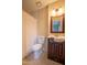 Cozy bathroom with vanity sink, framed mirror, standard toilet, and shower with white curtain at 7712 Falcon Rest Cir, Raleigh, NC 27615