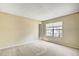 Bright bedroom featuring neutral walls, carpet floors, and a window providing natural light at 7712 Falcon Rest Cir, Raleigh, NC 27615