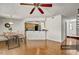 Hardwood floors flow throughout this open-concept dining and living room adjacent to kitchen bar at 7712 Falcon Rest Cir, Raleigh, NC 27615