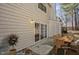 Exterior view showing patio with backyard furniture, sliding glass door, and potted plant at 7712 Falcon Rest Cir, Raleigh, NC 27615