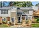 Charming townhouse with gray siding, black shutters, and well-maintained landscaping at 7712 Falcon Rest Cir, Raleigh, NC 27615