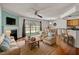 Open concept living room with hardwood floors, fireplace and a large sliding glass door at 7712 Falcon Rest Cir, Raleigh, NC 27615