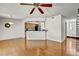 Open concept living space featuring hardwood floors, a kitchen bar, and a dining area at 7712 Falcon Rest Cir, Raleigh, NC 27615