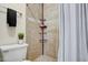 This is a tiled shower with a shower caddy and toilet at 7712 Falcon Rest Cir, Raleigh, NC 27615