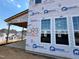 Exterior shot of a home under construction, showing window placement and building wrap at 79 Willow Cameron Way, Angier, NC 27501