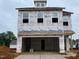 Two-story home with visible Barricade wrap and windows awaiting finishing touches at 79 Willow Cameron Way, Angier, NC 27501