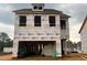New construction home featuring a two-car garage and durable weather-resistant barrier wrap at 79 Willow Cameron Way, Angier, NC 27501