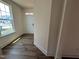 A bright foyer with wood-look floors and a large window by the front door at 79 Willow Cameron Way, Angier, NC 27501