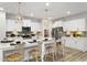 Modern kitchen featuring an island with a breakfast bar, stainless steel appliances, and pendant lighting at 79 Willow Cameron Way, Angier, NC 27501