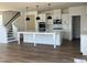 Spacious kitchen with white cabinets, a large island and stainless steel appliances at 79 Willow Cameron Way, Angier, NC 27501
