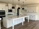 Modern kitchen featuring white cabinetry, an island and stainless steel appliances at 79 Willow Cameron Way, Angier, NC 27501